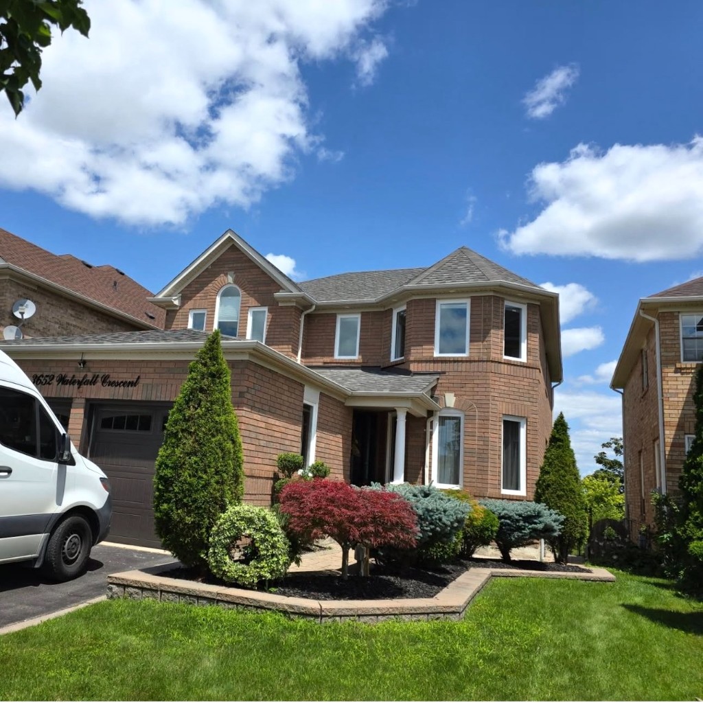 Professional white-framed window installation on a residential exterior